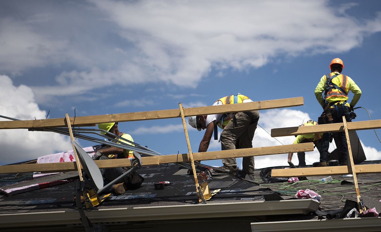 Fox River Roofing crew on a roof deck in St. Charles, staging shingles under a bright sky
